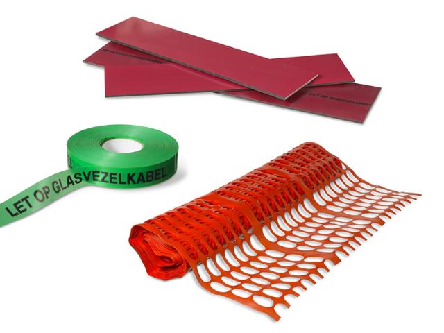 Various underground cable warning materials, including red plastic cover plates, a green warning tape labeled