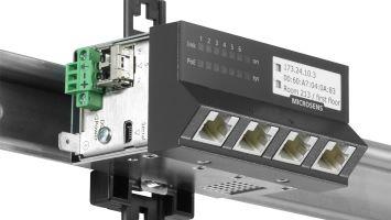 Industrial Ethernet switch mounted on a DIN rail, featuring multiple RJ45 ports, LED indicators, and labeled with IP address and room information.